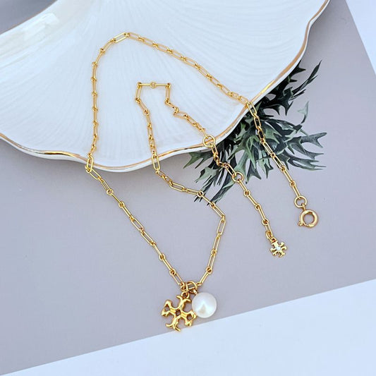 Gold-tone logo charm necklace with round white pearl pendant and linked chain
