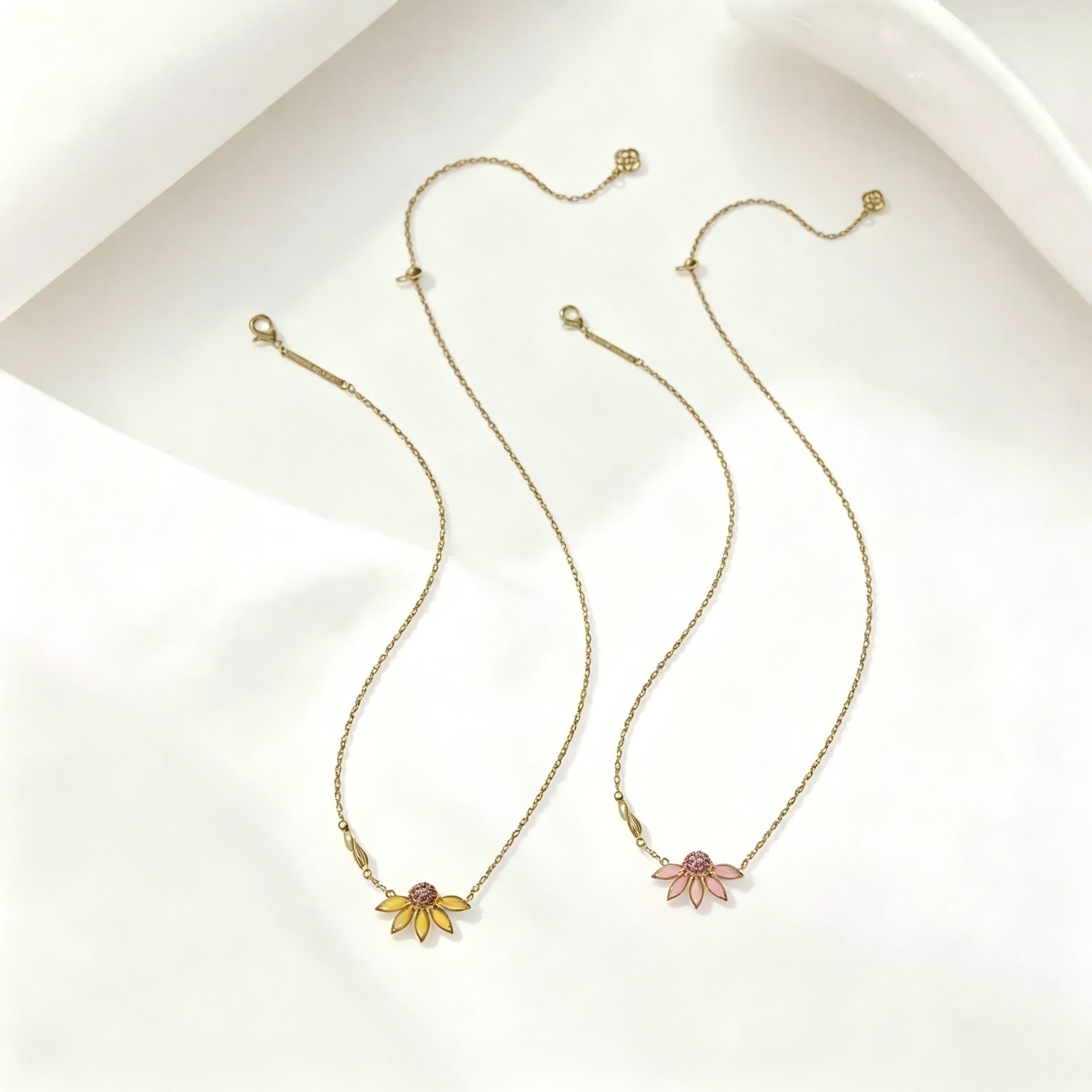 Gold-tone flower pendant necklace set with daisy charms and rhinestone centers