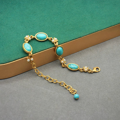 Vintage turquoise oval glass necklace with gold chain, bow links, and oval pendants