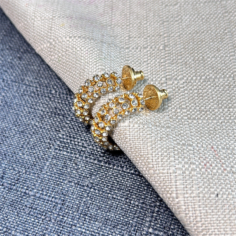 Gold-tone hoop earrings with clear cubic zirconia stones and stud backs