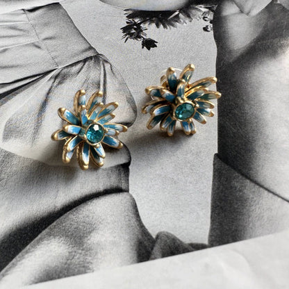 Gold enamel flower stud earrings with blue petal accents and teal center stones
