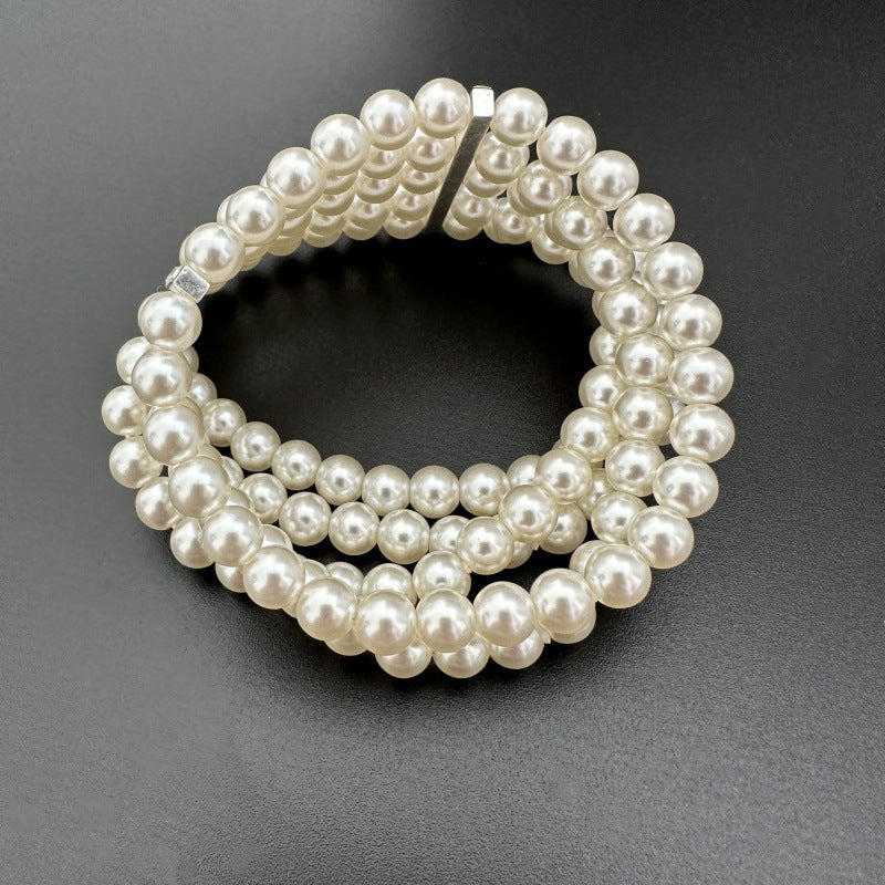 Faux pearl elastic bracelet, stacked rows with rhinestone bar detail at the front