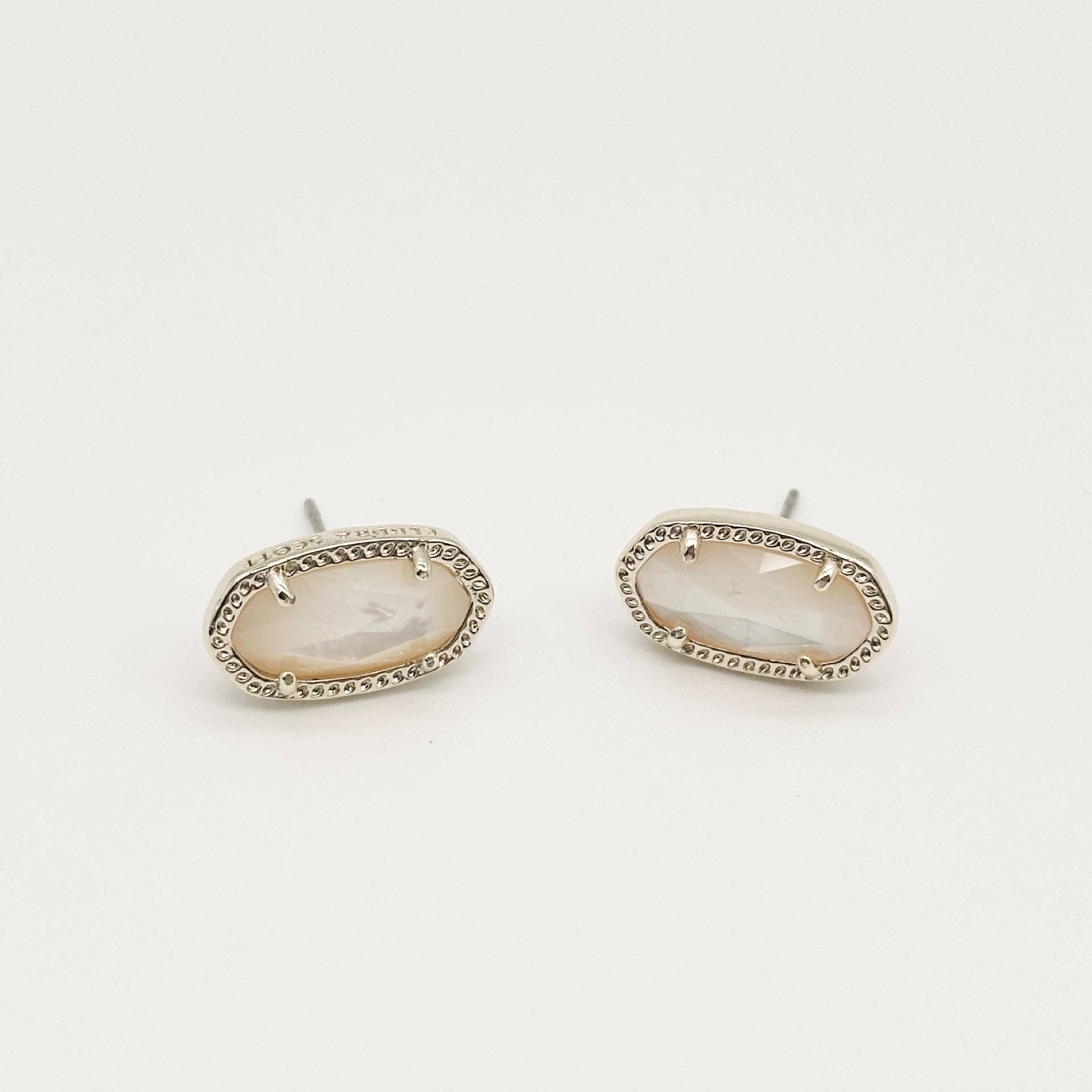 Kendra Scott oval gemstone stud earrings with pale pink crystal in silver-tone bezel setting