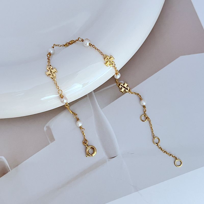 Gold-tone chain bracelet with freshwater pearls and logo cutout link charms