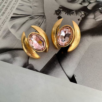 Gold-tone oval crystal stud earrings with pink faceted stones