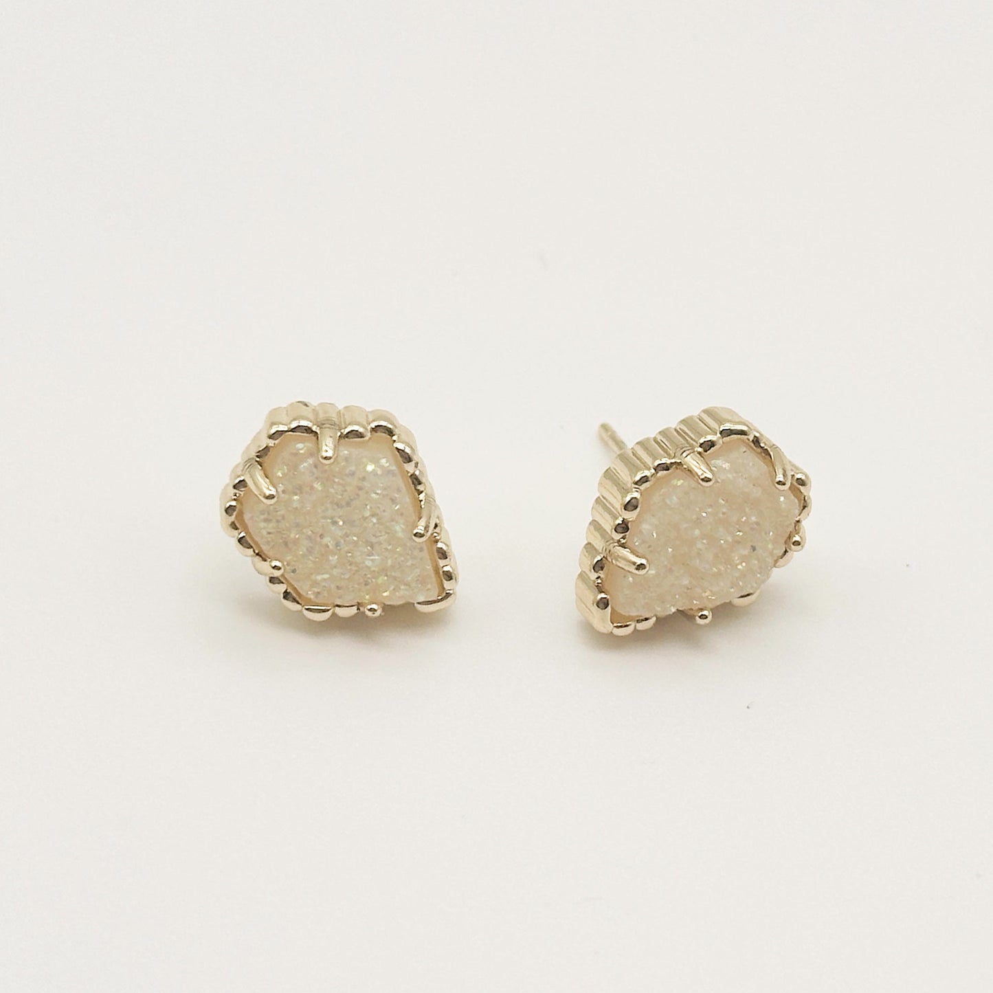 Pair of irregular rhombus stud earrings with druzy white stone and gold-tone scalloped bezel