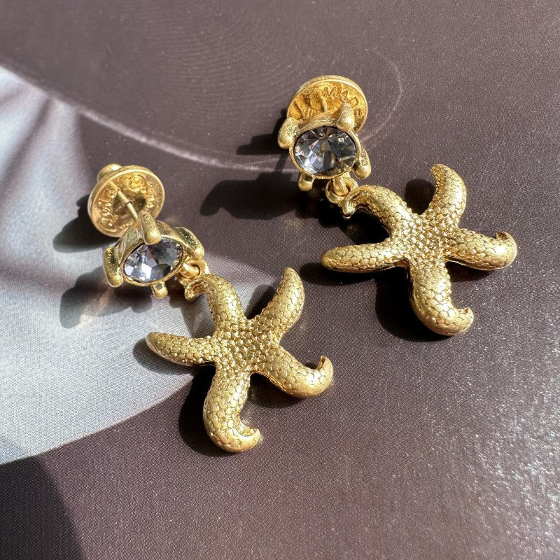 Vintage gold starfish stud earrings with clear round accents