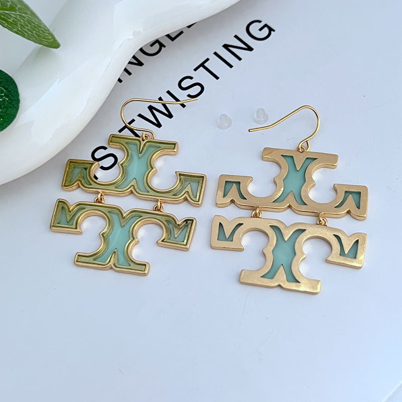 Acrylic logo drop earrings with gold-tone hooks and teal/green cutout letters