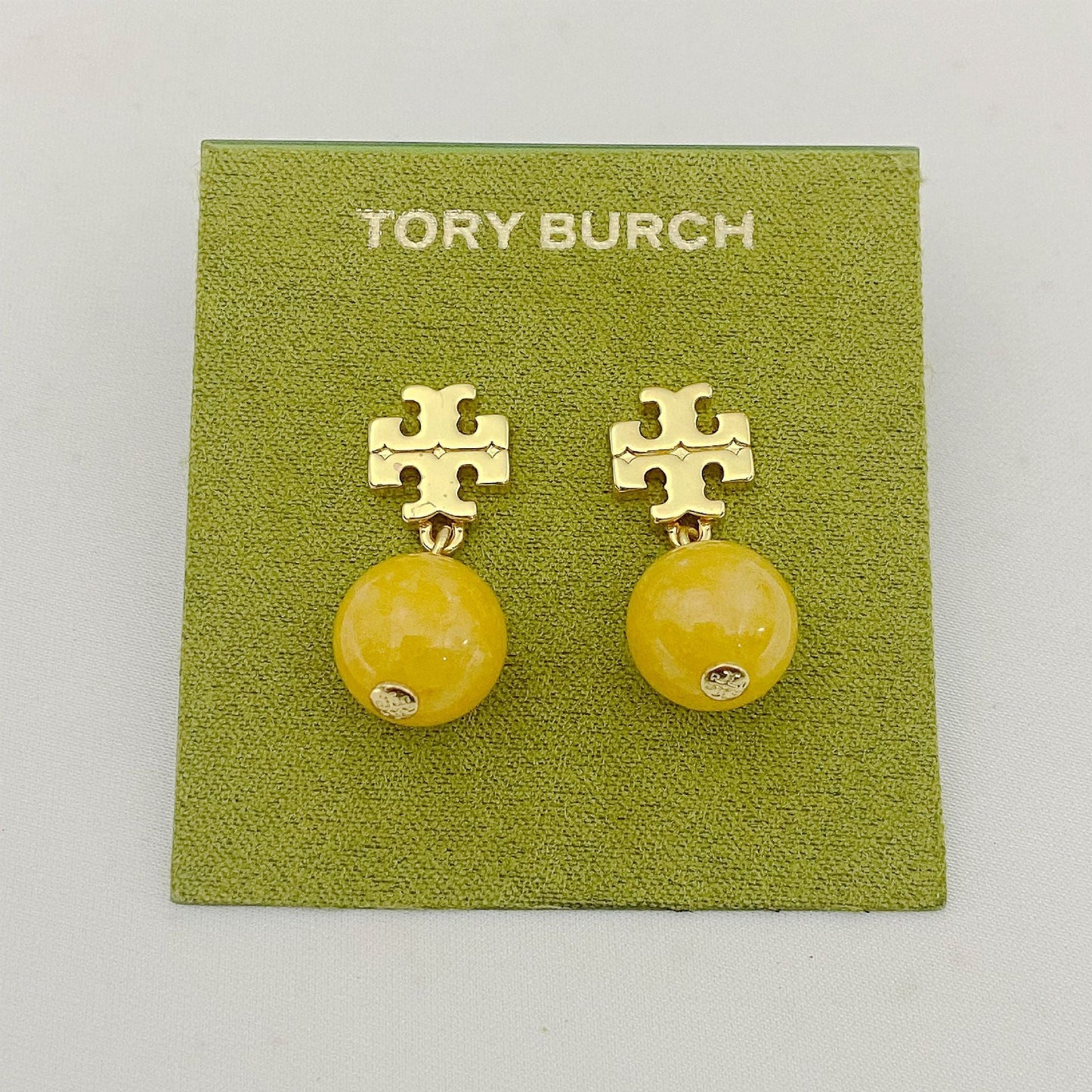 Tory Burch logo pendant earrings with yellow agate beads and gold logo studs