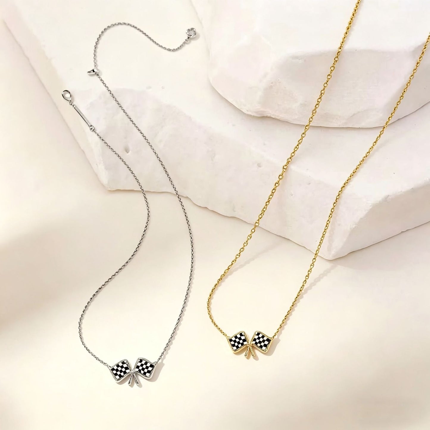 Silver and gold chain necklaces with checkered flag bow pendants