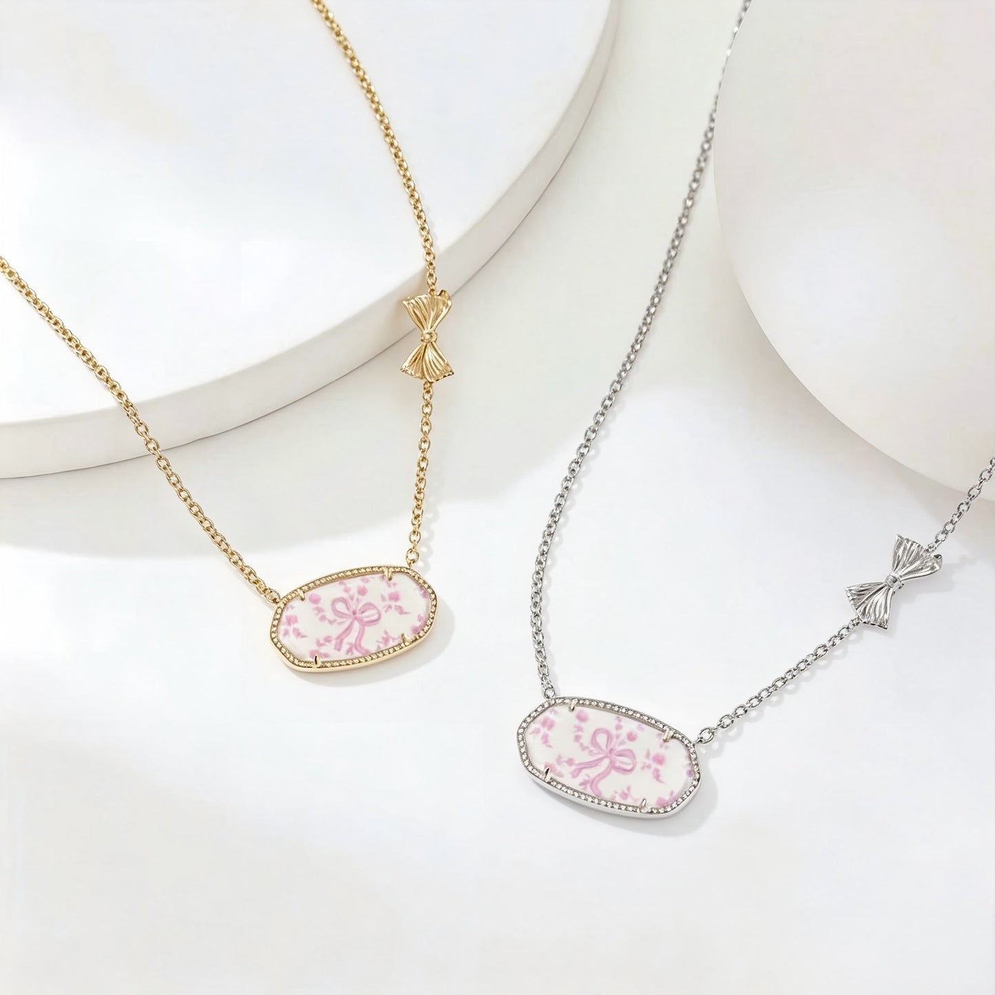 Gold- and silver-tone oval pendant bow necklaces with pink floral enamel