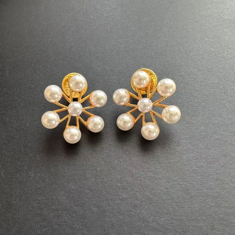 Gold-tone and white pearl flower earrings with round pearl petals and stud backs