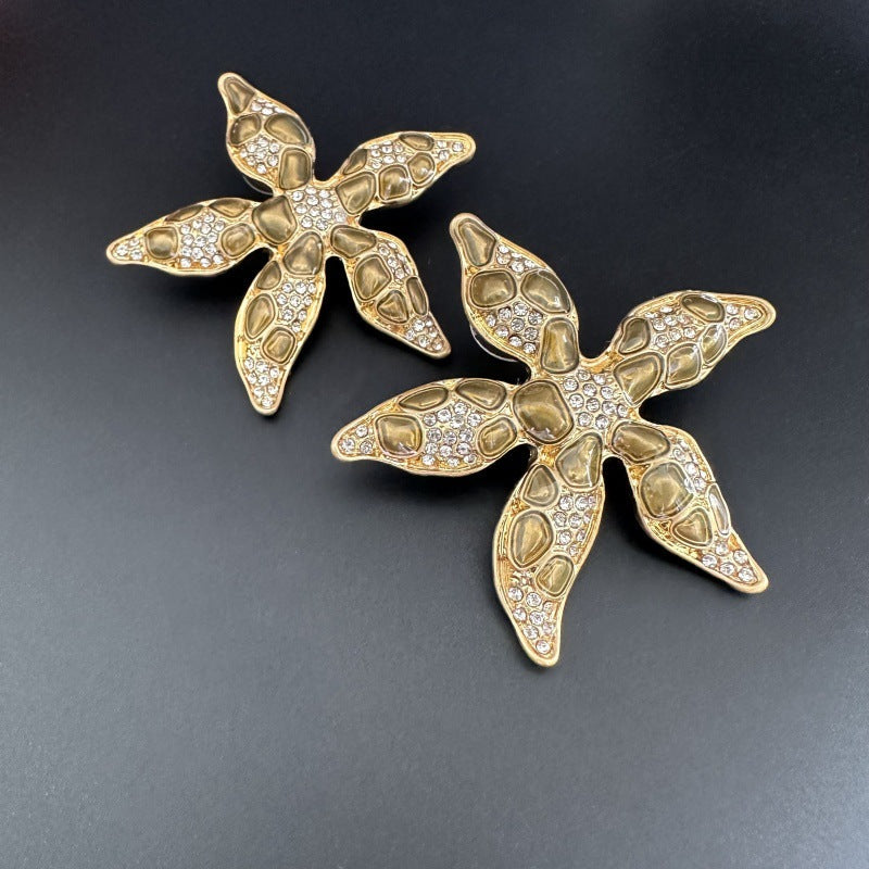 Starfish flower earrings in gold tone with clear rhinestone detailing, no colored enamel