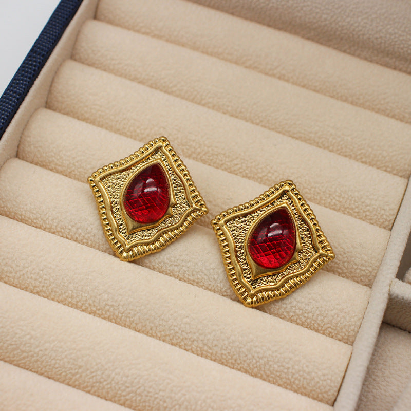 Vintage square stud earrings with red glass-like gemstone inserts in gold-tone frames
