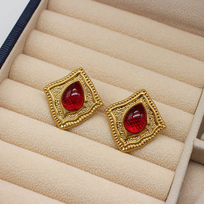 Vintage square stud earrings with red glass-like gemstone inserts in gold-tone frames