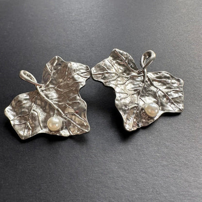 Silver-tone ivy leaf stud earrings with white pearls and curled vine details