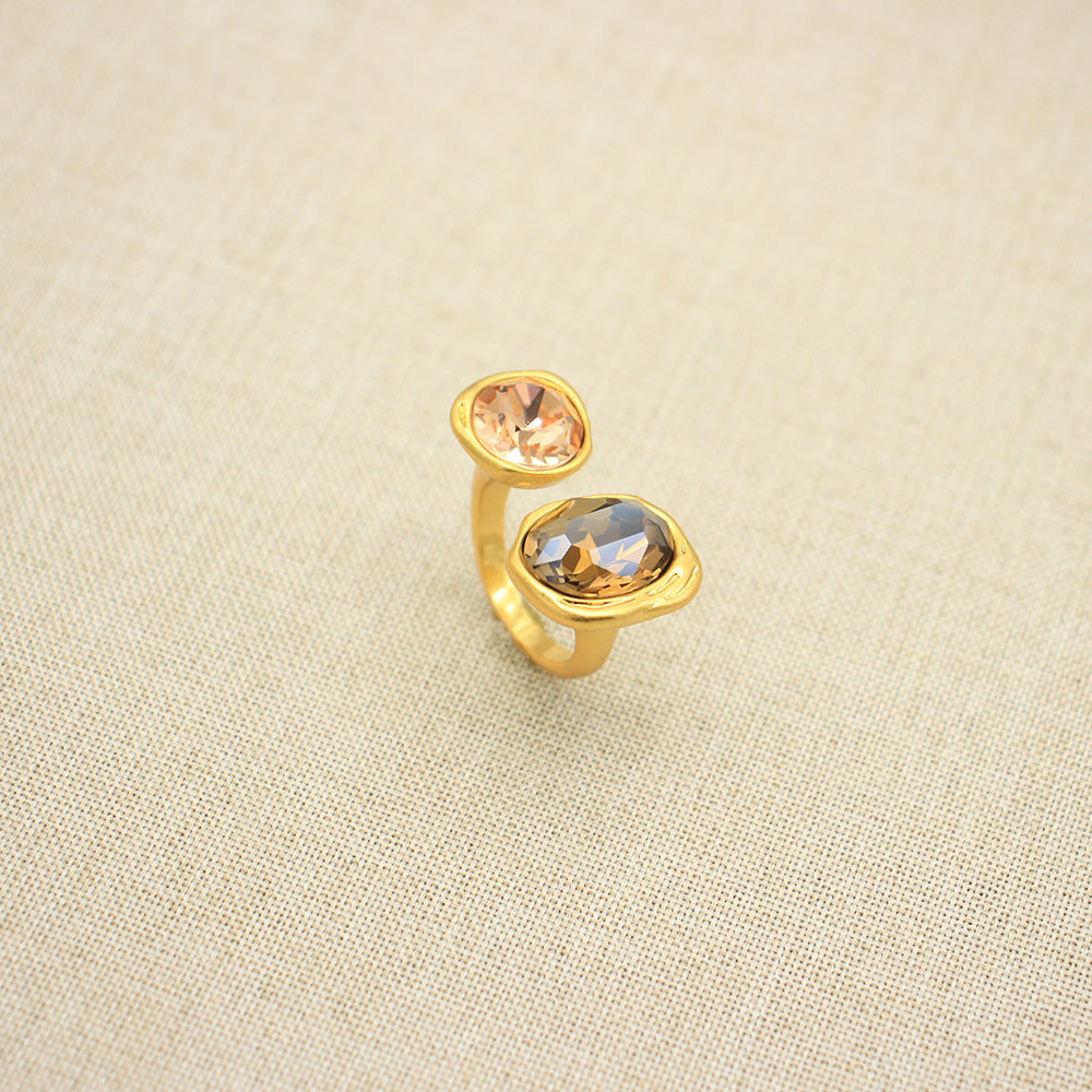 Adjustable open band gemstone ring with peach oval top stone and warm gold oval bottom