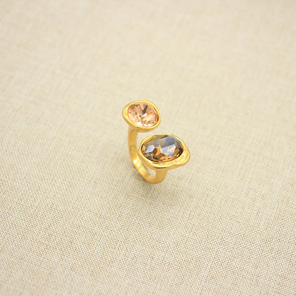 Adjustable open band gemstone ring with peach oval top stone and warm gold oval bottom
