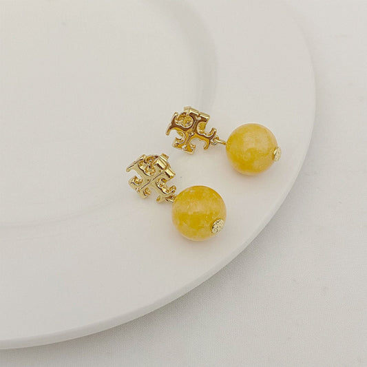 Gold-tone logo bead pendant earrings with round yellow agate-style beads