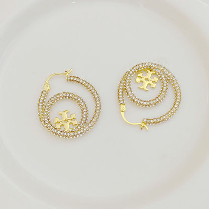 Gold hoop earrings with full diamond pavé and centered Tory Burch logo disk