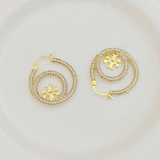 Gold hoop earrings with full diamond pavé and centered Tory Burch logo disk