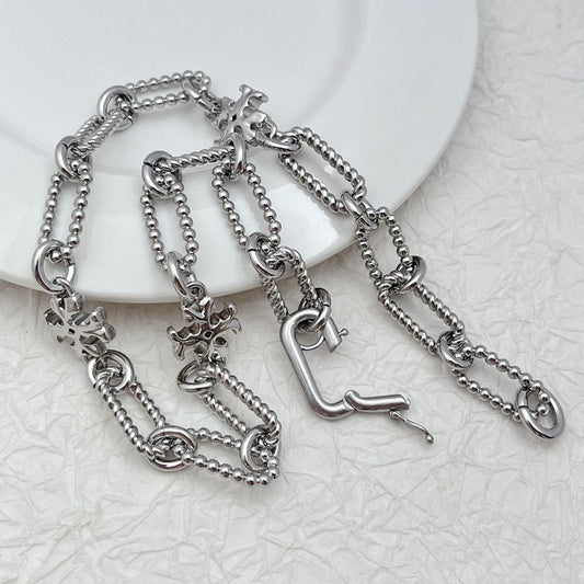 Silver square chunky chain logo bracelet with clover-like emblem charm links and toggle