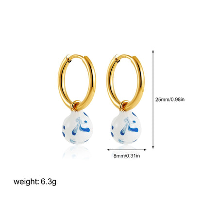 Gold-tone hoop earrings with small blue marble teardrop charm, 25mm