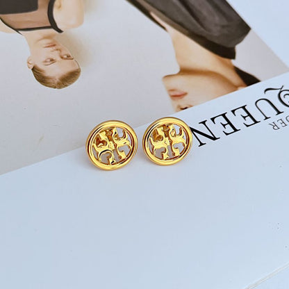 Gold round logo metal stud earrings on white display, pair centered