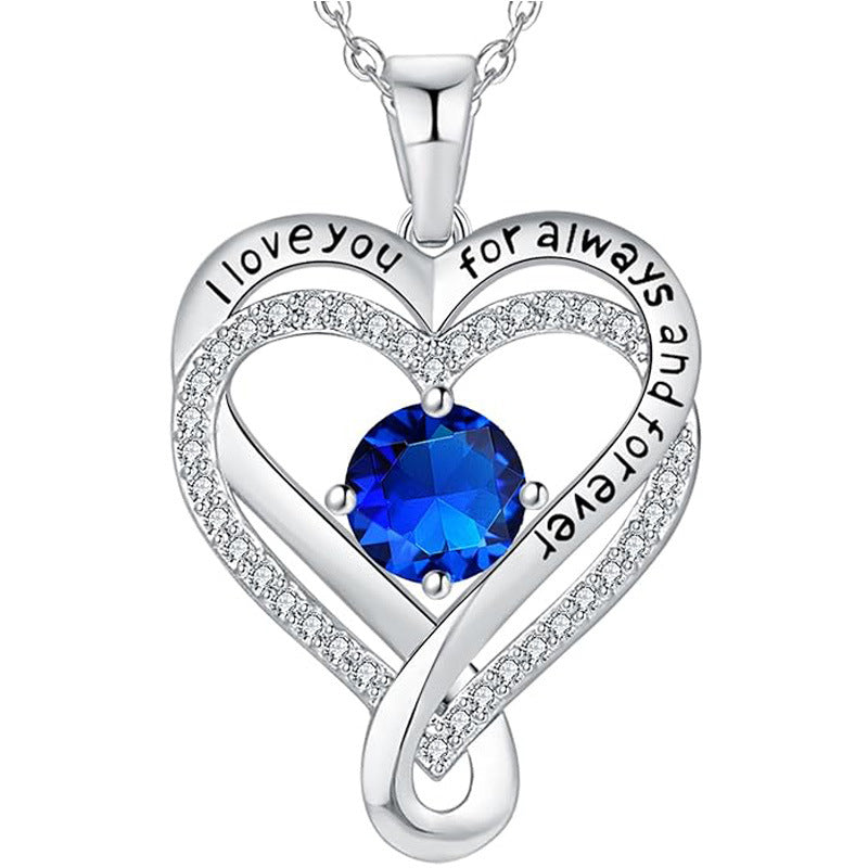 Silver heart pendant necklace with dark blue round gemstone and pave double-heart frame