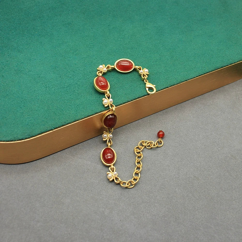 Vintage red oval glass dangling earrings with gold chain and bow links