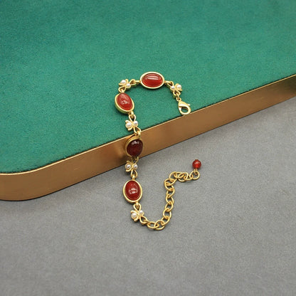 Vintage red oval glass dangling earrings with gold chain and bow links