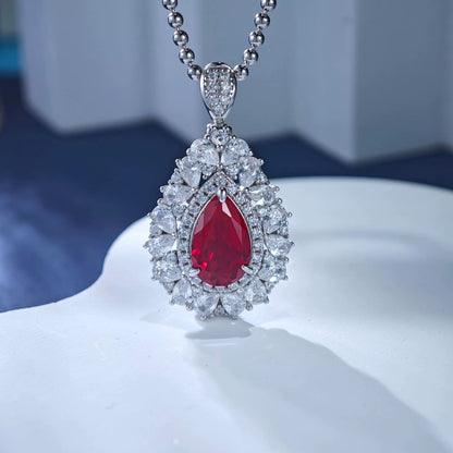 Sterling silver ruby teardrop pendant necklace with diamond halo and beaded chain