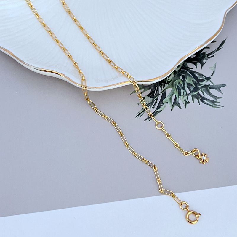 Gold-tone linked chain necklace with toggle clasp end and small logo charm