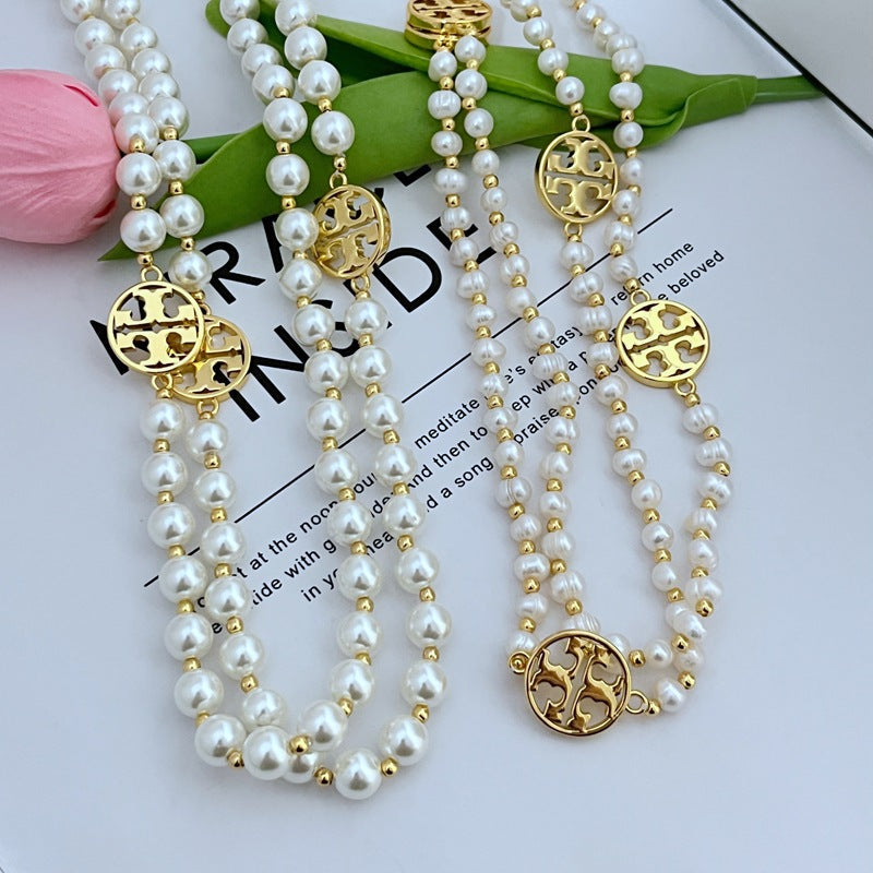 Tory Burch round hollow letter pearl sweater necklace
