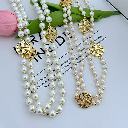Tory Burch round hollow letter pearl sweater necklace