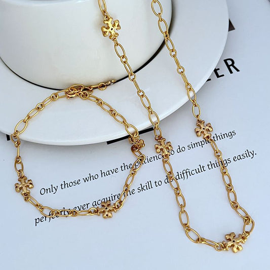 Gold-tone chain bracelet and necklace with clover logo link charms