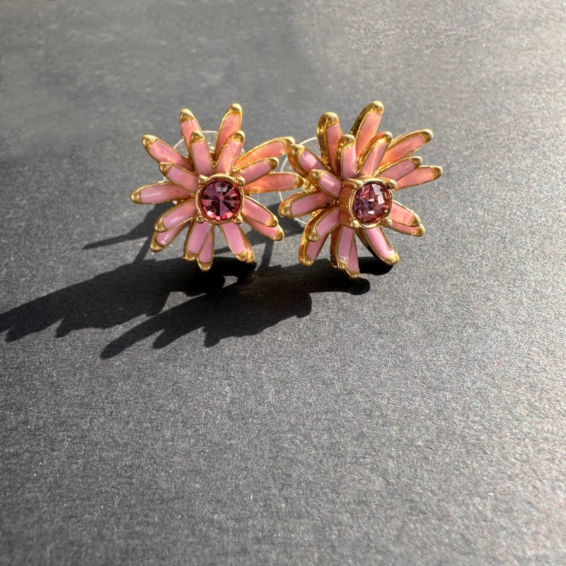 Gold enamel flower stud earrings with pink petal accents and pink center stones