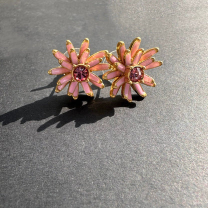 Gold enamel flower stud earrings with pink petal accents and pink center stones