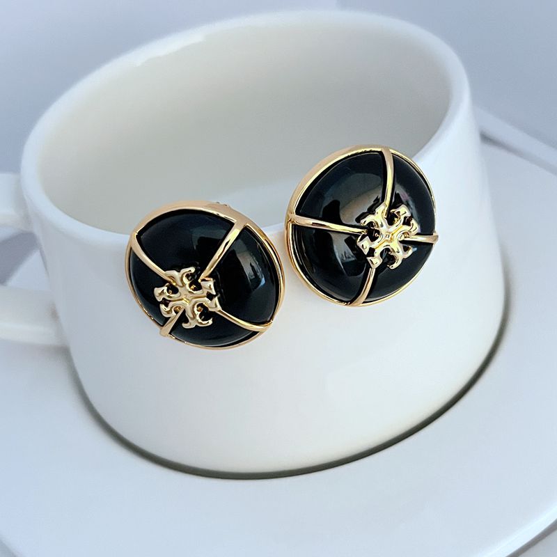 Tory Burch black enamel button stud earrings with gold-tone emblem in round bezel