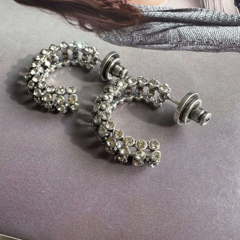 Silver-tone hoop earrings with clear cubic zirconia stones and push backs