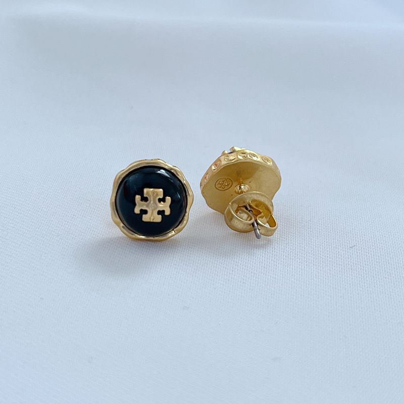 Metal stud earrings showing dark blue front with gold back posts