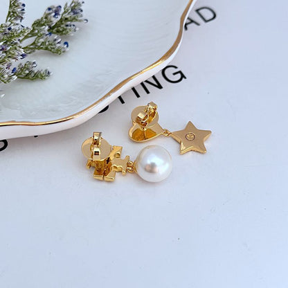 Gold-tone star and heart drop earrings with rhinestone detailing and white pearl