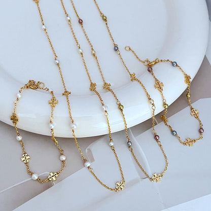 Gold-tone chain bracelets with freshwater pearls and logo charm links