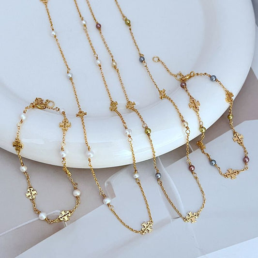 Gold-tone chain bracelets with freshwater pearls and logo charm links