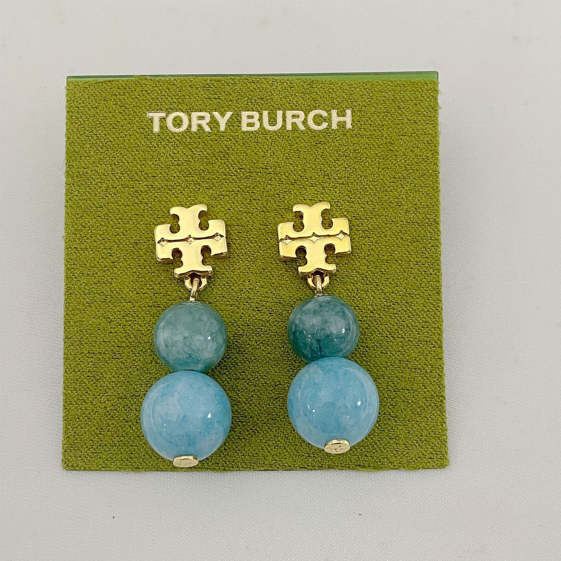 Tory Burch logo pendant earrings with blue agate beads and gold logo connectors