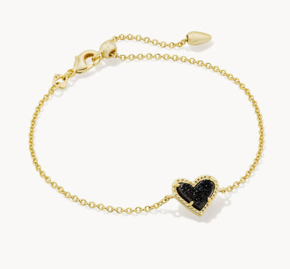 Adjustable heart charm bracelet with gold-tone chain and black crystal heart pendant.