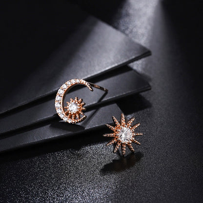 Rose gold tone crescent moon and sunburst diamond stud earrings with pavé