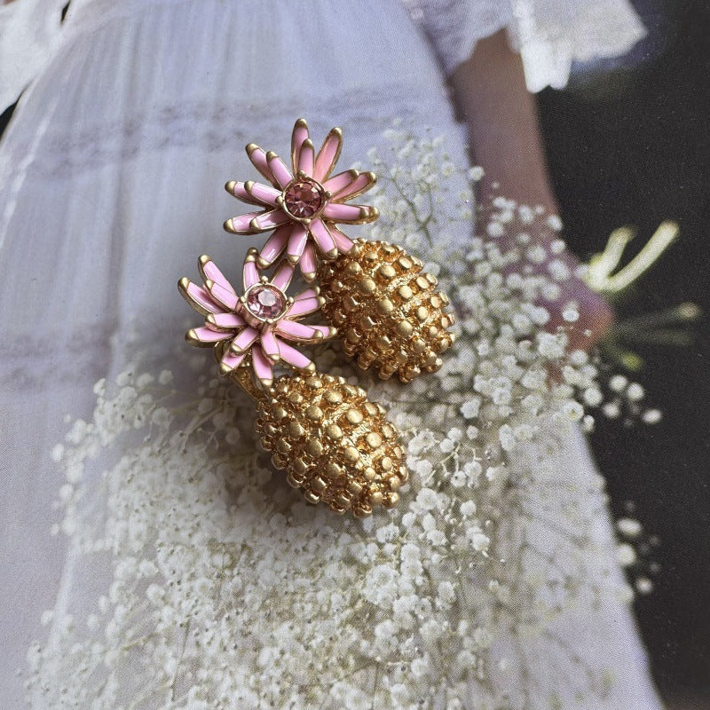 Enamel flower and pineapple diamond earrings with pink flower tops and gold textured pineapple drops.