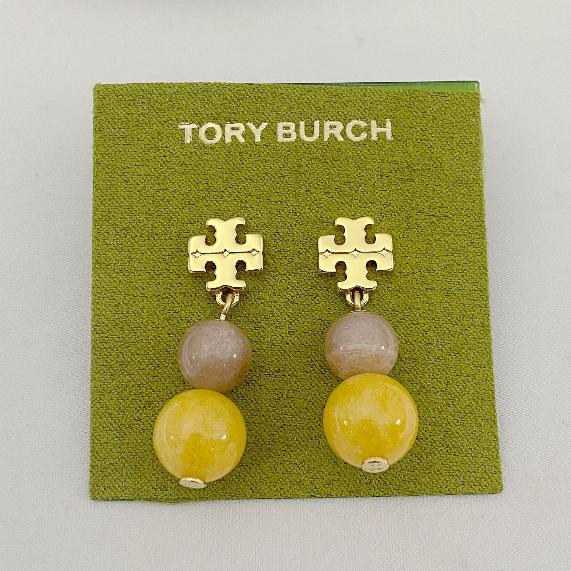 Tory Burch logo pendant earrings with gold-tone emblem and two-tone agate beads, yellow drops