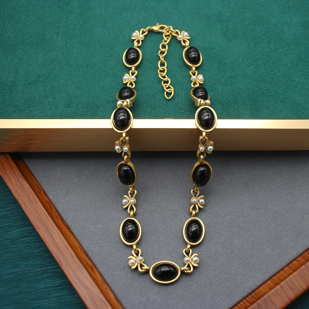 Vintage oval black glass necklace and earring set with gold chain and butterfly charms